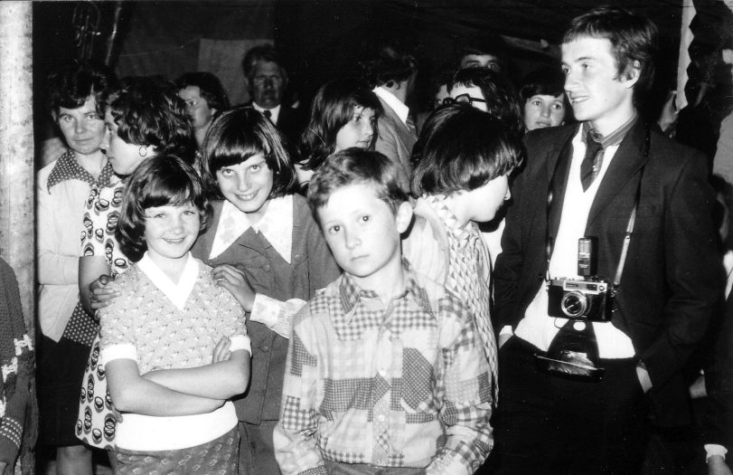 The ethnographer (with his Yashica camera) among the children at a crowded wedding reception, 1977 (photographer unknown)